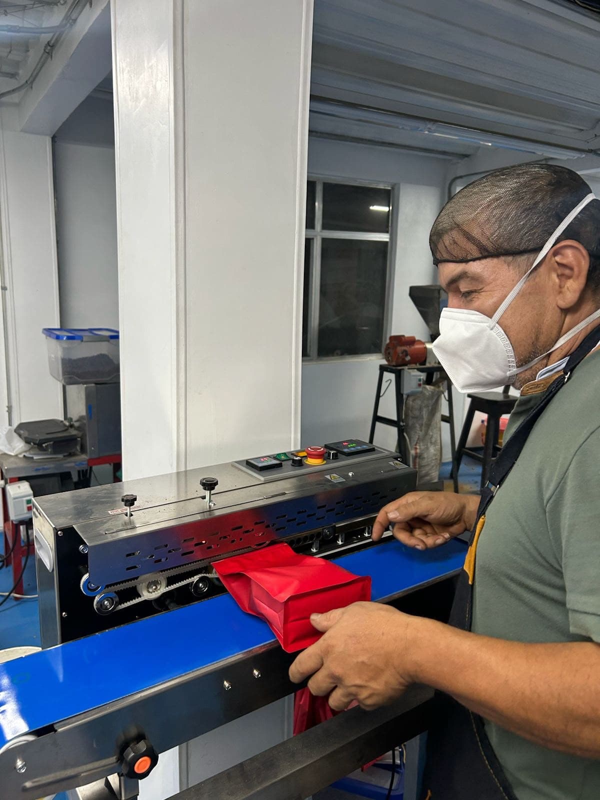 Sellando una bolsa de café en la máquina selladora